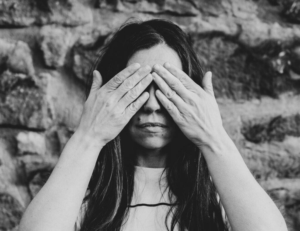 Woman covering her eyes with her hands.